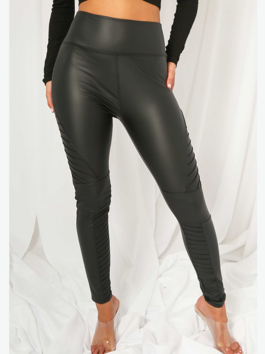 Model wears panelled high waisted leggings with a pu biker leggings design. Model faces the front, the panelled pu leggings can be seen. 