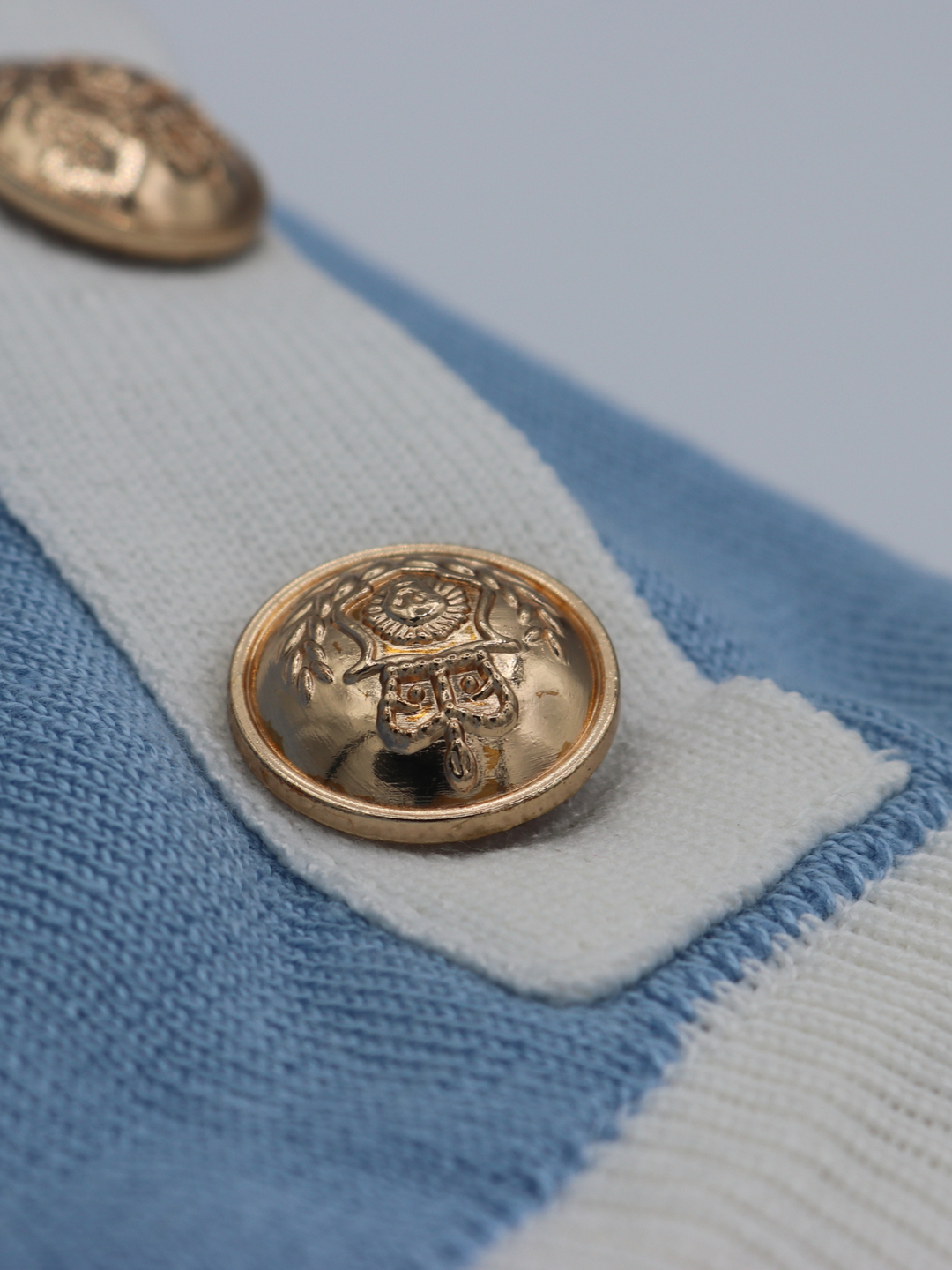 close up of the gold militay button detailing on the co ordinated set. 