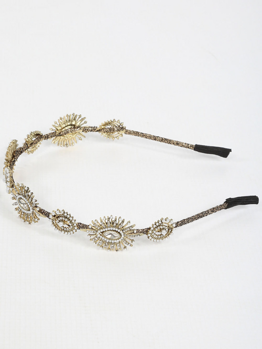 Picture shows the side of the metal head band in gold, the hair band has jewels and beaded design. 