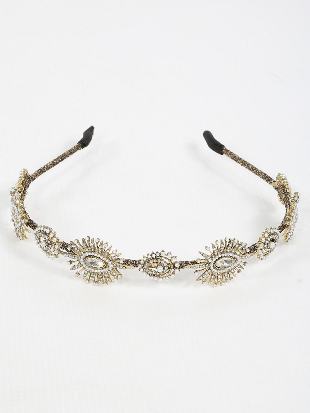 Picture shows the front of the metal head band in gold, the hair band has jewels and beaded design. 