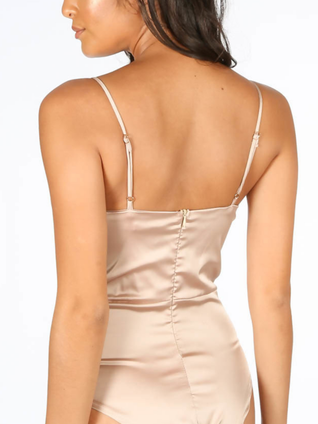 Model wears luxe satin nude bodysuit with front lace panelling and scallop lace trim to the neckline and spaghetti straps. Closeup of the back of the bodysuit, showing the zip back closure and adjustable spagehtti straps.