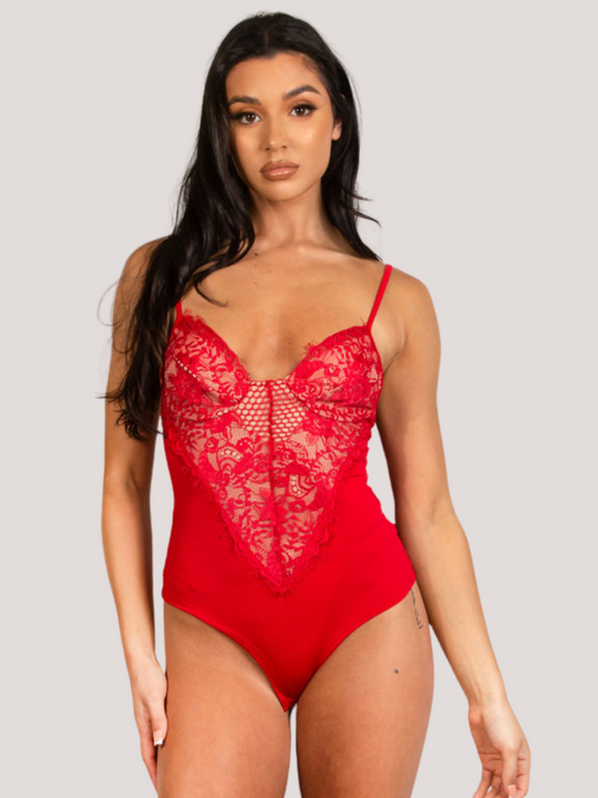 Model wears a red bodysuit with lace panel detailing. Model faces forward with both hands by her sides. 