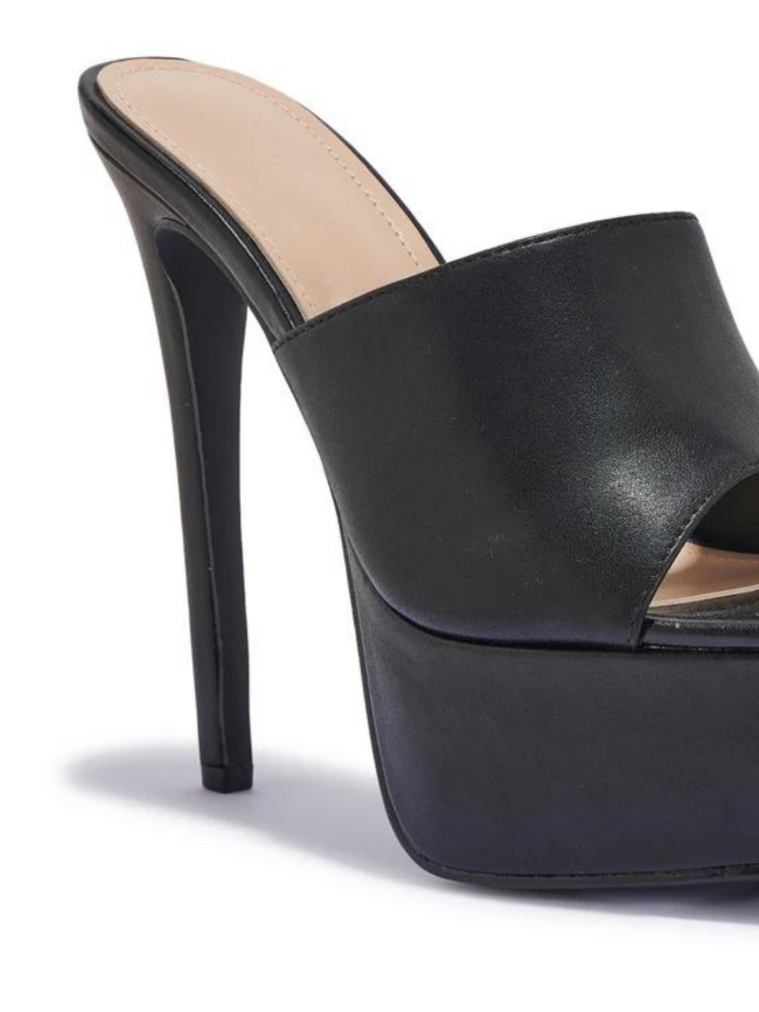 Black heeled mules that have a thick platform base and stiletto shoes. The picture shows a close up of the side of the black platform, showing the thick platform base. 